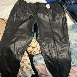 Black faux leather joggers .